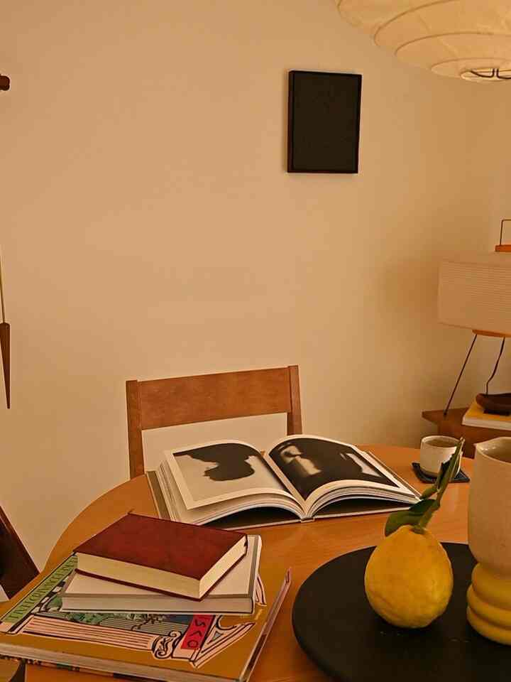 Warm beige dining room with wood-toned table and chair, natural elements creating a cozy atmosphere
