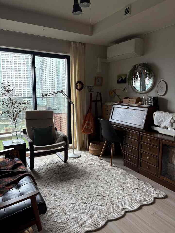 Natural modern 6-tatami living room with white walls and curtains, wooden furniture, armchair, and rug creating a cozy atmosphere