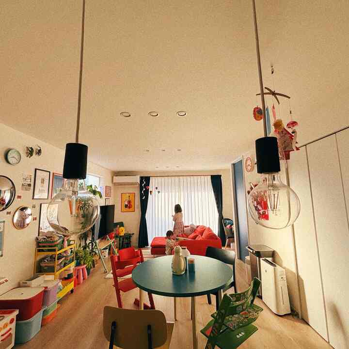 3-person household living and dining space featuring red sofa and navy curtains with a cozy atmosphere