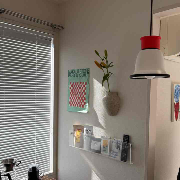 Bright white and transparent Nordic-style kitchen corner featuring pendant light and wall shelf with a cozy, clean ambiance