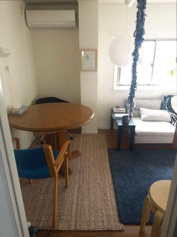 White and wood tone living-dining space for two, featuring natural elements and a cozy Nordic-inspired interior