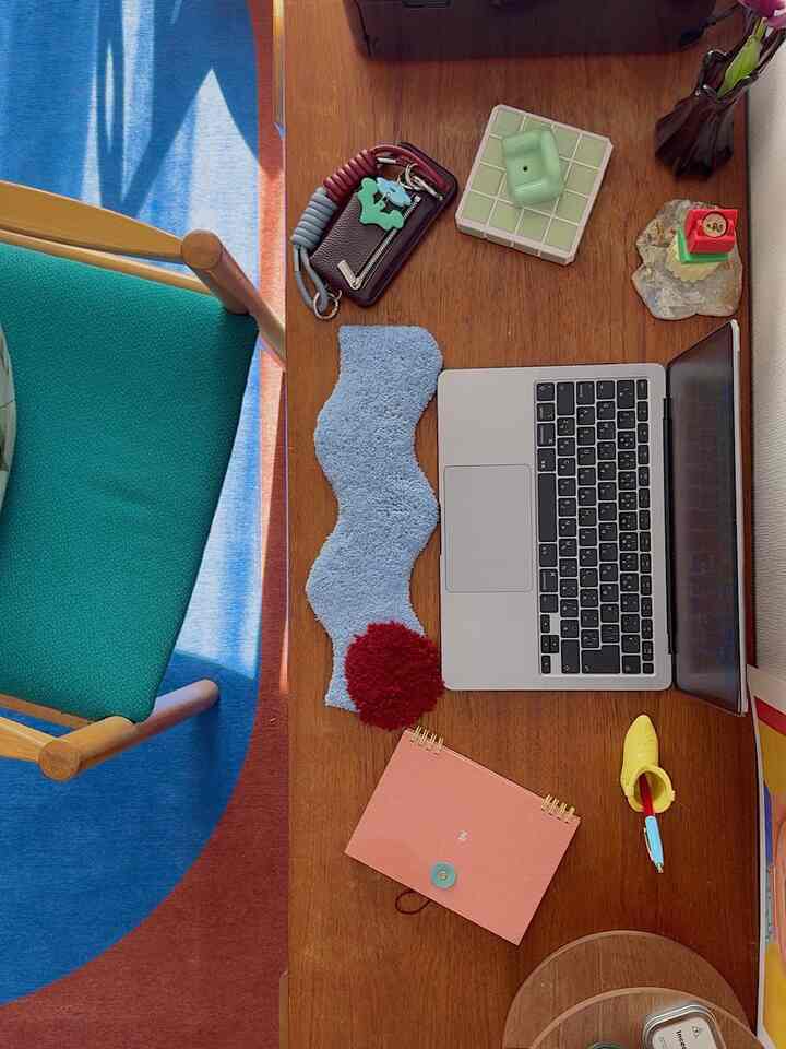 Blue and brown toned home office space featuring a wooden desk and green chair, creating a cozy workspace