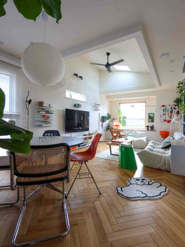 Mid-Century Modern living room with dominant white and wood tones, featuring a dog-shaped rug and stylish furniture