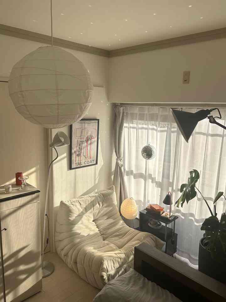 Natural color modern small living room featuring a comfortable sofa and curtains with cozy atmosphere