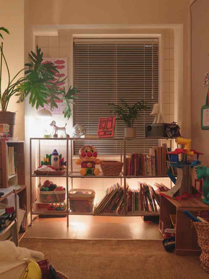 Beige-toned kids' room featuring shelves with toys and books, creating a cozy and moody atmosphere