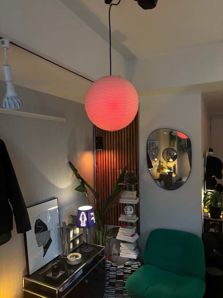 Modern cozy 8-tatami studio with red pendant light and green armchair, featuring ambient indirect lighting