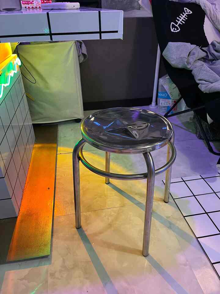 Monotone small room interior featuring a silver steel stool