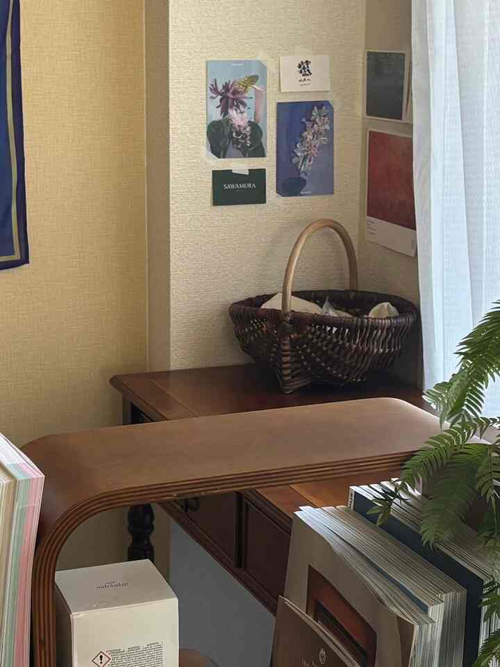 Natural space featuring brown wood-toned desk, corner basket, and greenery plant adding warmth and calm atmosphere