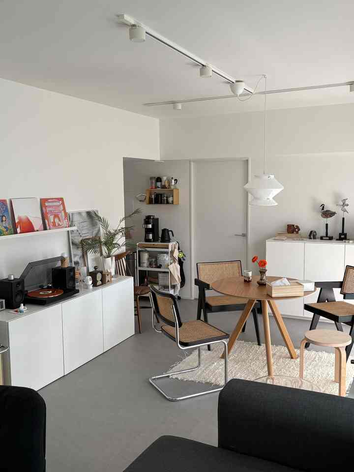 White and wood tone dining room featuring a round table and chairs creating a cozy atmosphere