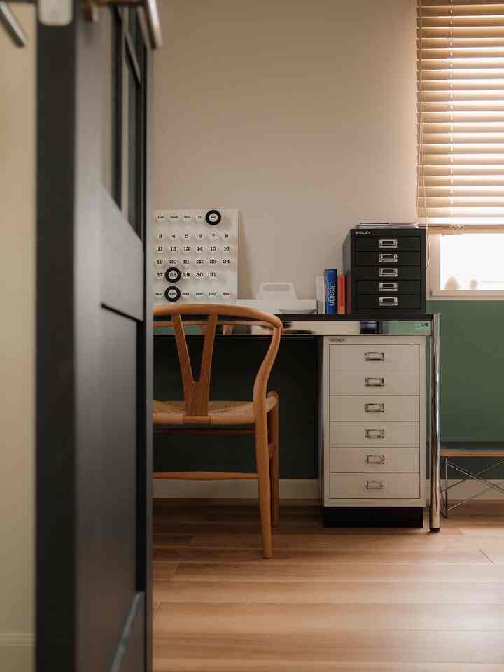 White and brown toned workspace featuring Mid-Century Modern furniture in a compact, cozy setting