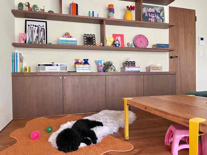 Wood-toned living room featuring custom storage cabinets and colorful decor with a cozy atmosphere