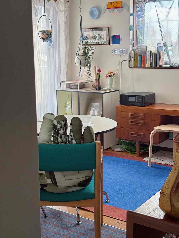 Natural color toned Nordic vintage dining and living room featuring wooden furniture, soft lighting, and charming decor