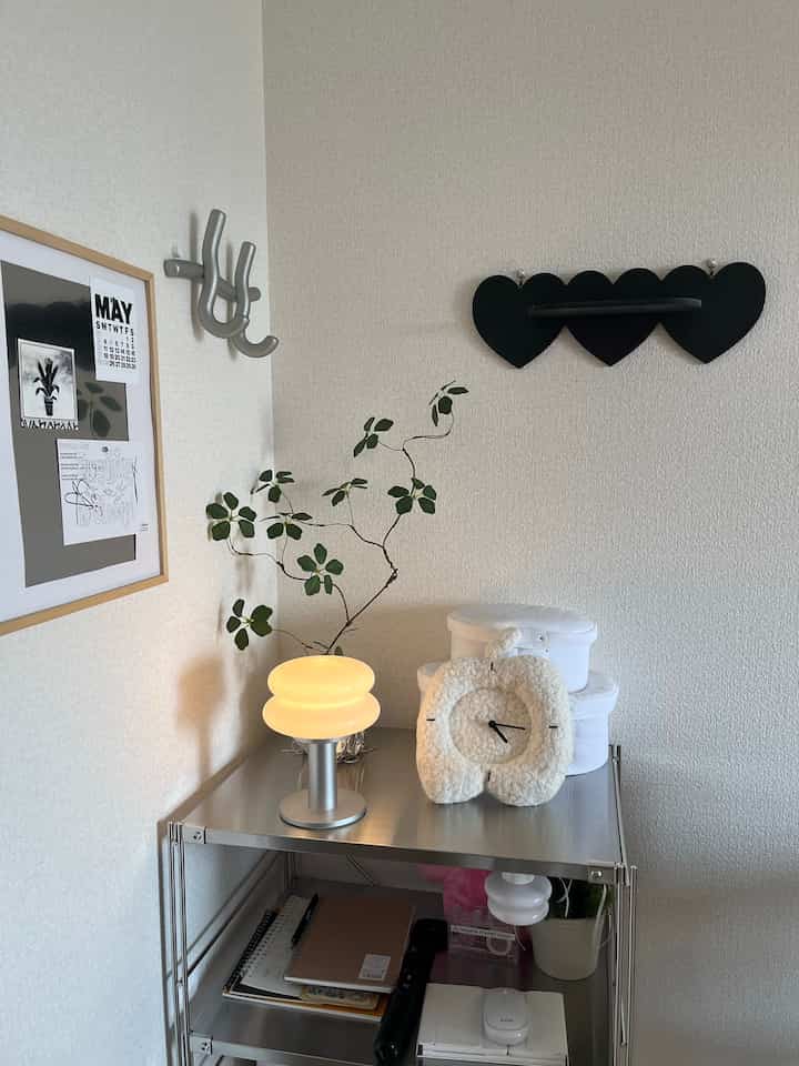Silver and white toned 1LDK room featuring a cat shelf, plant, and minimalist lighting with clean interior design