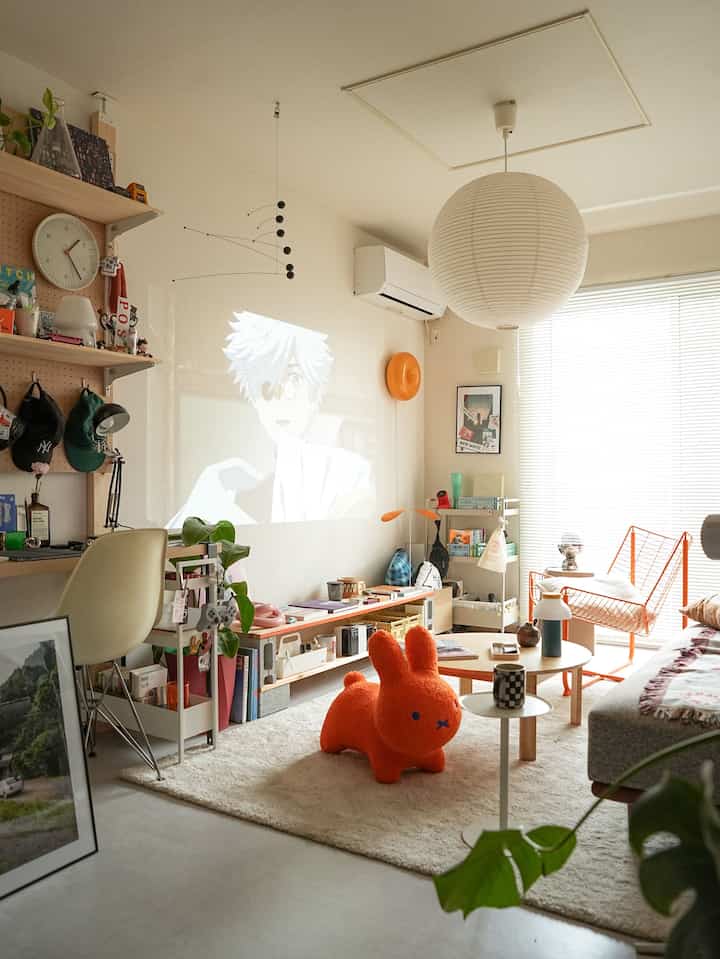 Beige and orange toned living room featuring sofa, coffee table, and a plush toy creating a cozy atmosphere