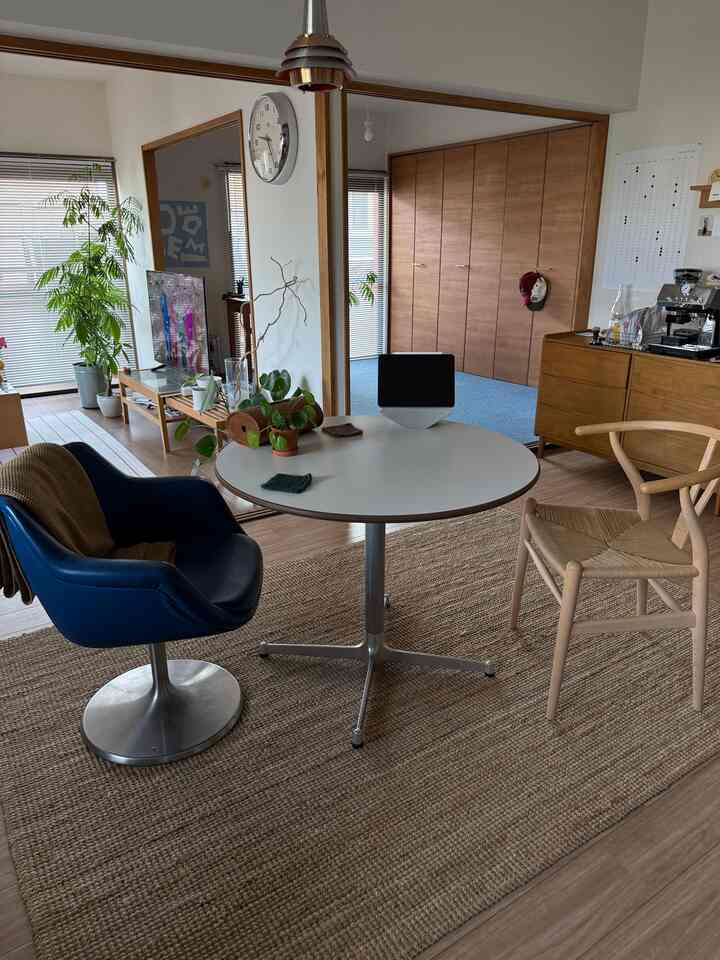 Natural wood tones and white blend in a living and dining area featuring home cafe elements with a cozy atmosphere