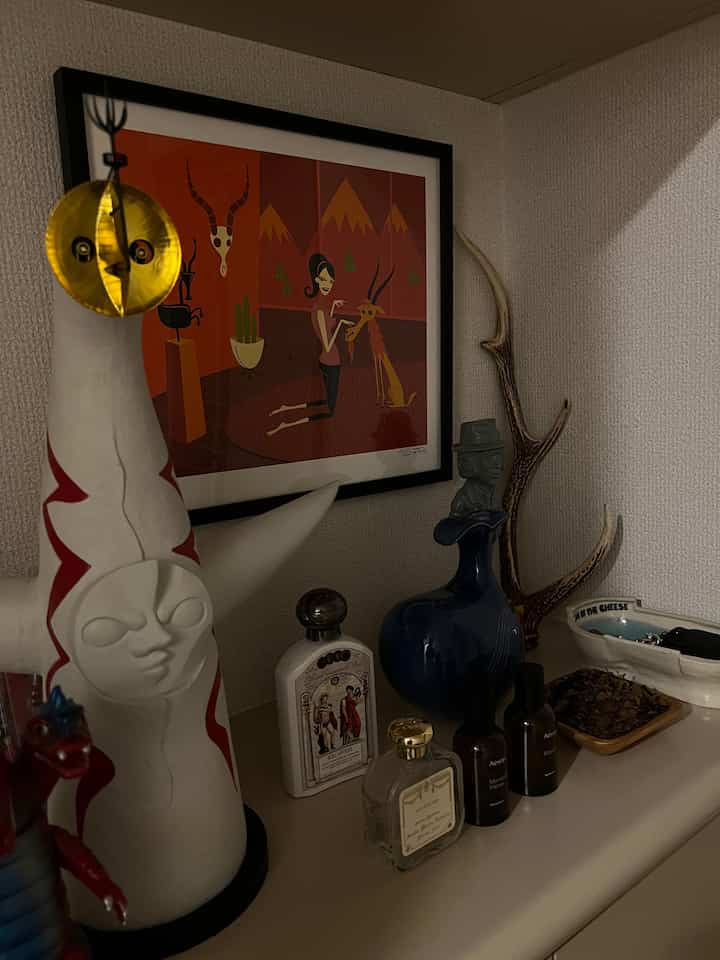 Brown and white toned entrance corner featuring unique statues and framed art, creating a cozy decorative space