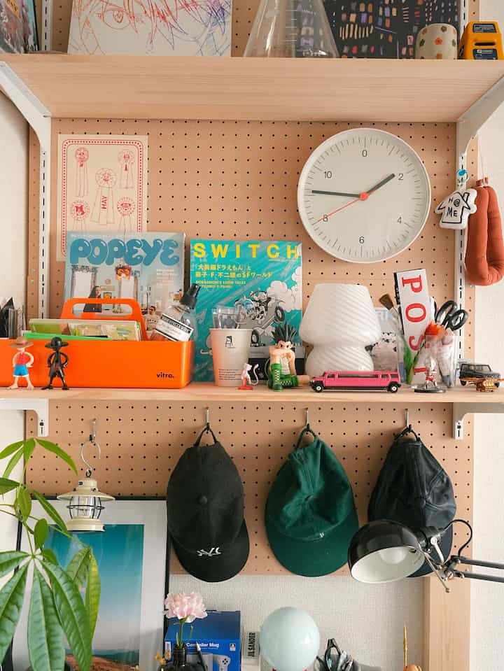 Natural color workspace featuring vintage-style items and a bright orange storage box on a tidy desk layout