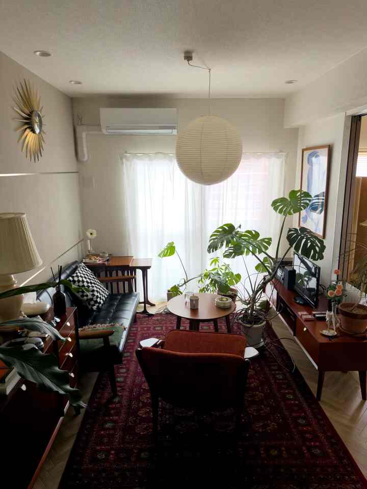 Beige and wood-tone natural living room featuring wooden furniture and leafy plants creating a cozy atmosphere