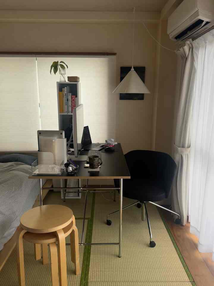 Natural tones and white walls define this studio home office with desk and chair, creating a practical atmosphere