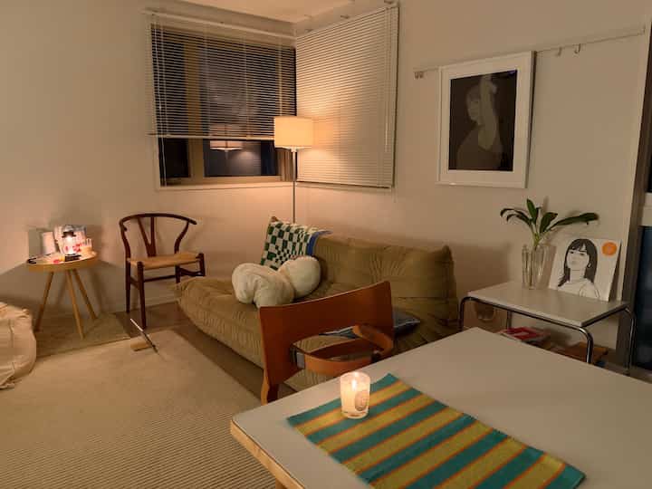 Warm beige-toned living room featuring sofa and side tables with a cozy ambiance