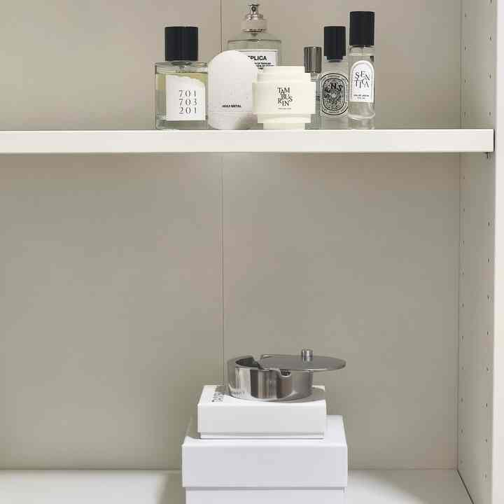 White and silver toned Korean interior featuring neatly organized trays and perfumes with a minimal aesthetic