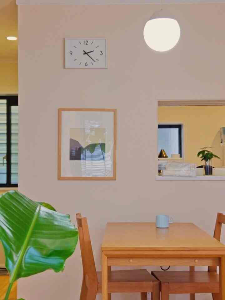 Natural-tone beige wall dining room featuring solid wood table and chairs with a clean, cozy atmosphere