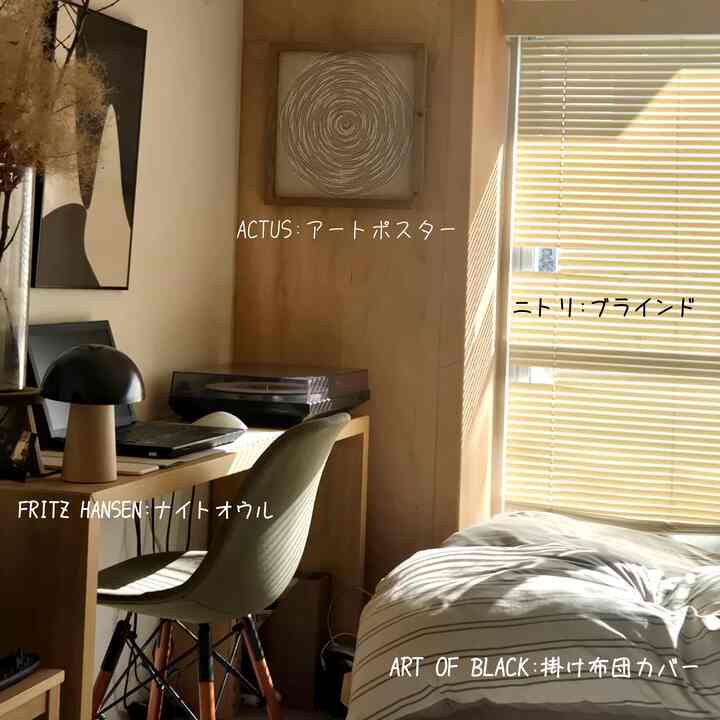 A cozy 1DK bedroom with warm wood tones and white colors, featuring a desk and a bed