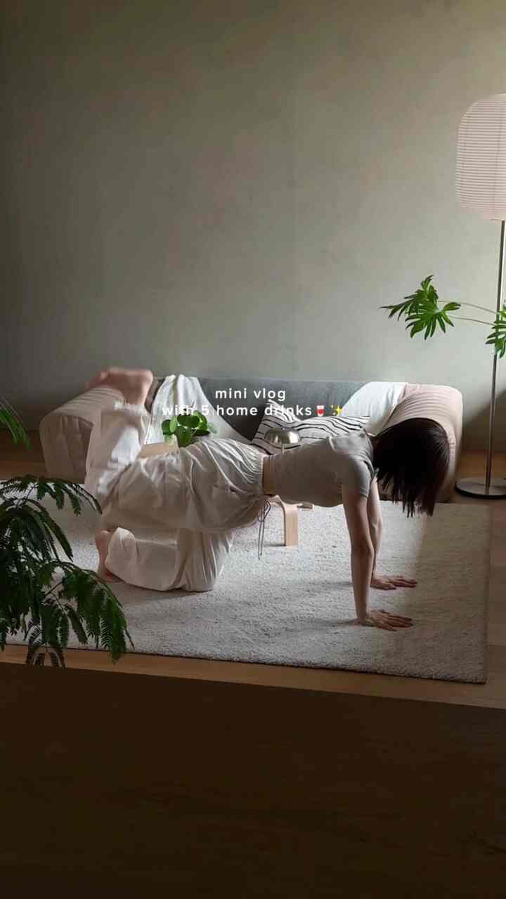 Beige and natural toned living room featuring a sofa, rug, and green plants with a minimalist interior style