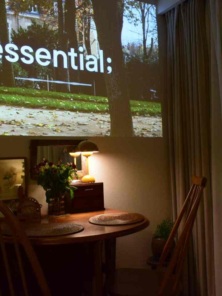 Cozy dining room with wood tones and warm yellow lighting, featuring a round table and table lamp