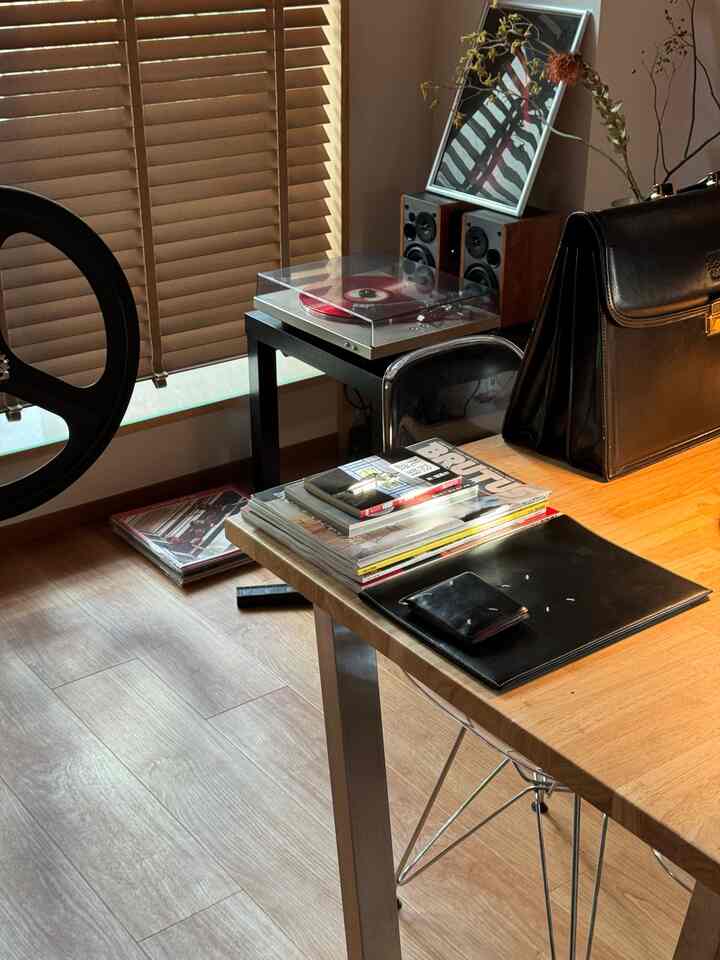 木目調と透明アクリル家具が調和した、一人暮らし向け1LDKのリビング、落ち着いた雰囲気の空間です。