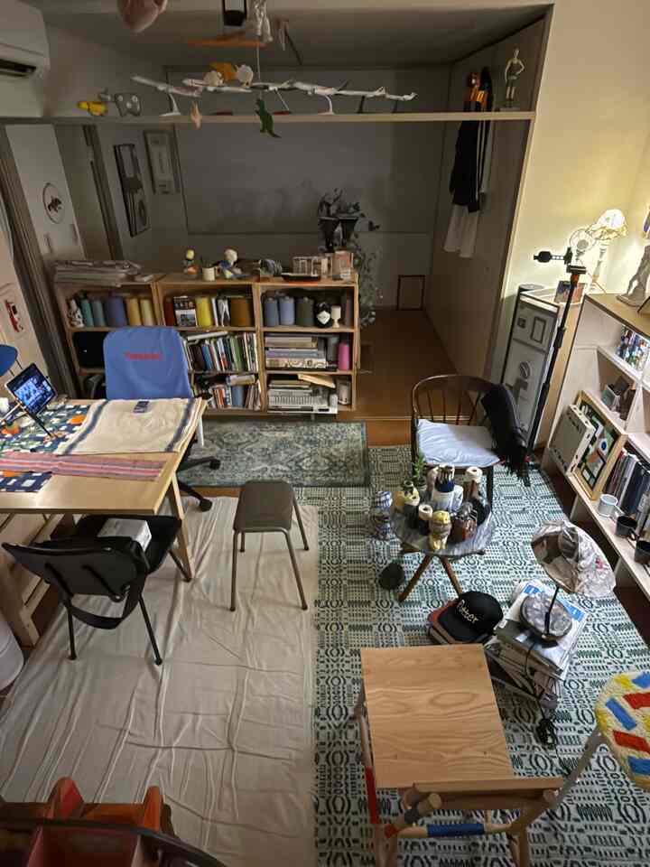 Natural tone 1LDK small room featuring bookshelves, vintage rugs, desk, and stool in cozy single household space