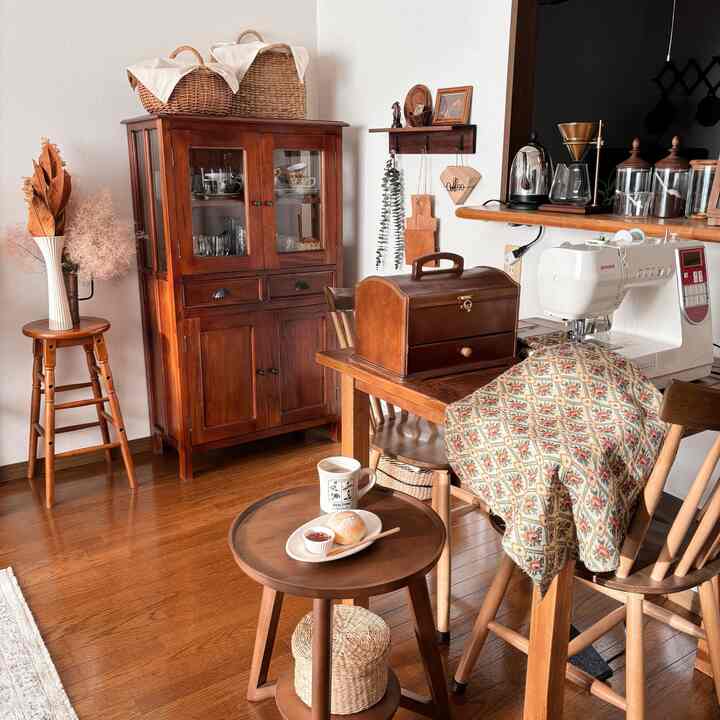 Vintage-style dining room featuring brown wood tones, home cafe elements and handcraft sewing activity with cushion cover in progress