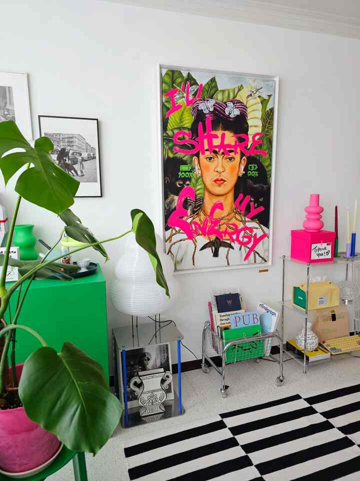 White walls with green furniture and large plant in a mid-century modern styled living room interior