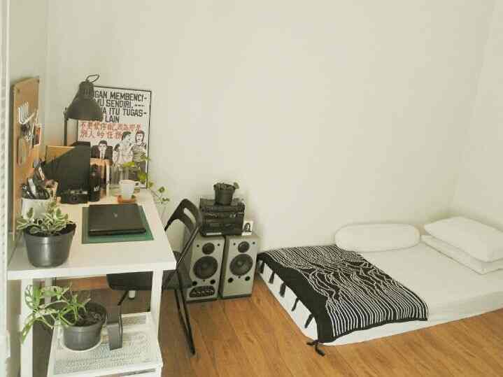 Minimal style small bedroom studio in dominant white and black monotone, featuring a desk on left and bed on right with organized layout