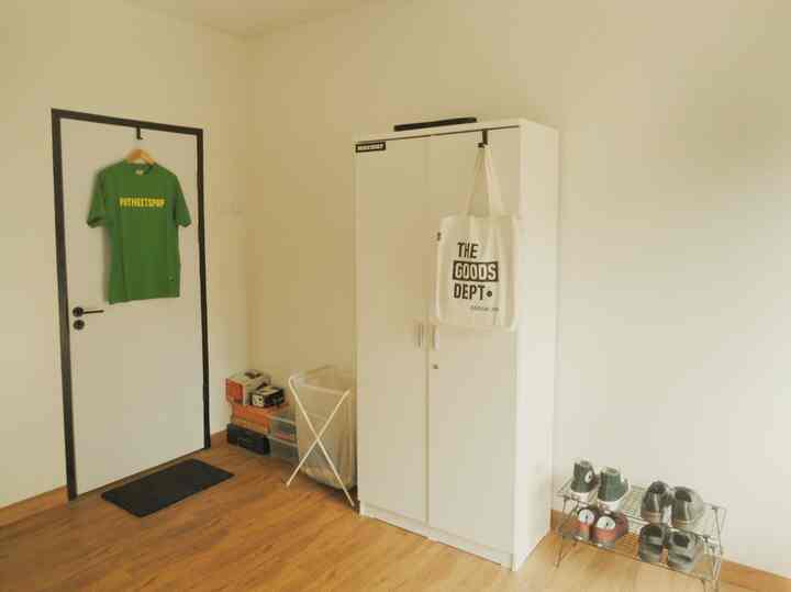 White and wood tone entrance featuring a neat wardrobe and organized shoe rack in a cozy space