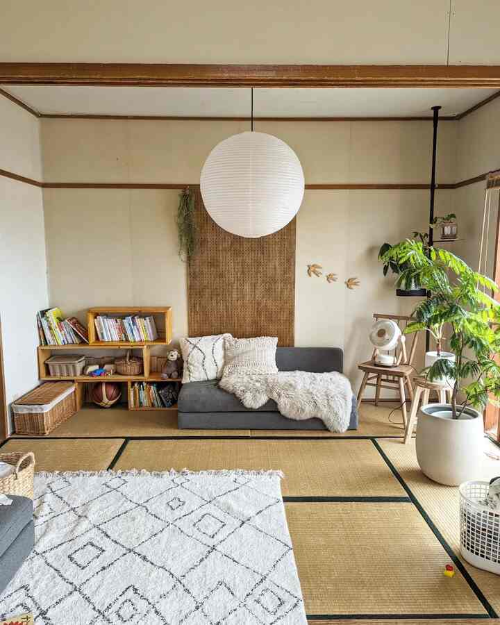 Natural-toned living room with white and brown hues, featuring a grey sofa, plants, and warm cozy atmosphere