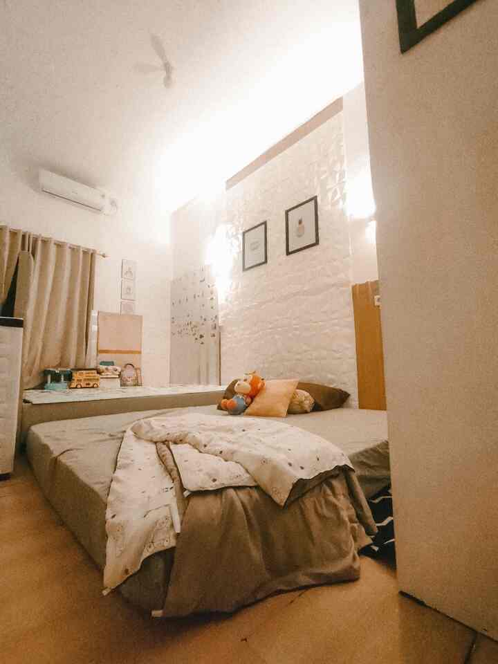 White and wood tone kids' bedroom featuring bed and toddler-friendly elements with cozy atmosphere