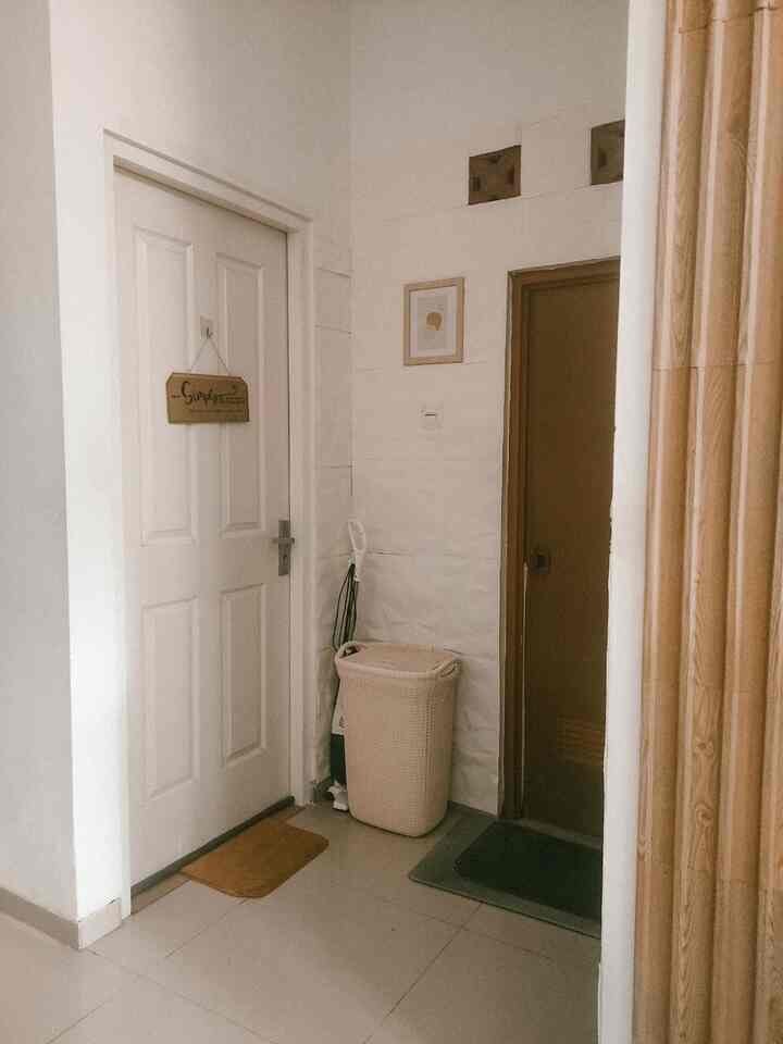 Beige and wood-tone small bathroom space featuring practical Japandi style with minimal decor elements
