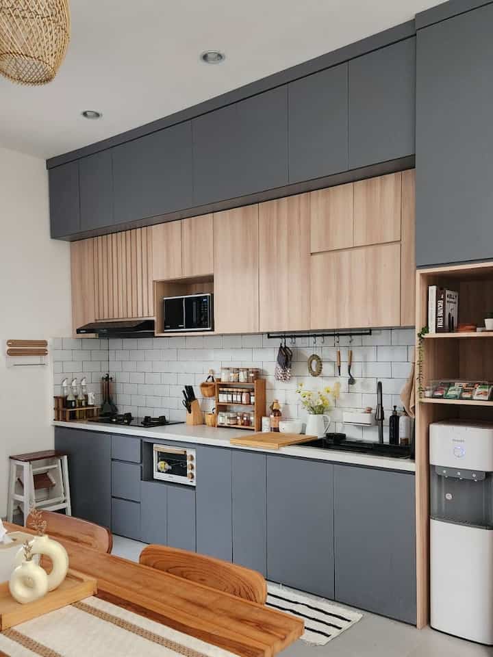 Wood tone and gray kitchen featuring dining table and smart storage ideas with a warm natural atmosphere