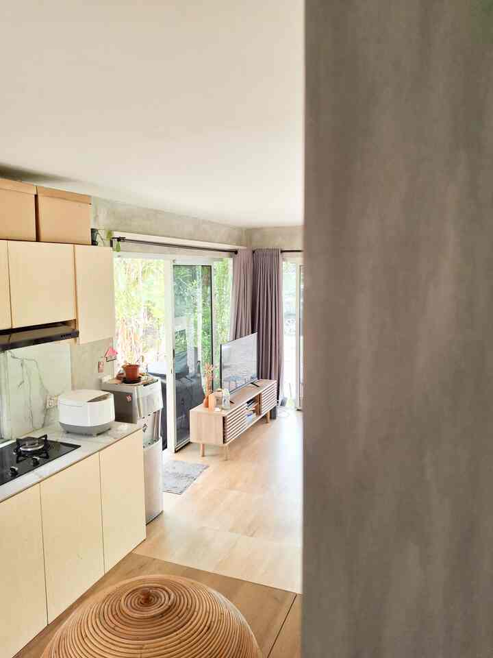 Natural color 1LDK space with gray curtains, featuring open kitchen and living room for a cozy atmosphere