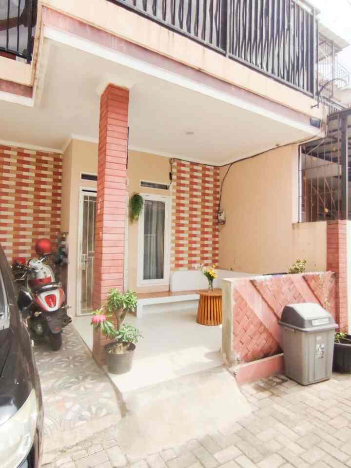 Beige and brown toned entrance outdoor area featuring a wooden coffee table and potted plants with a cozy atmosphere