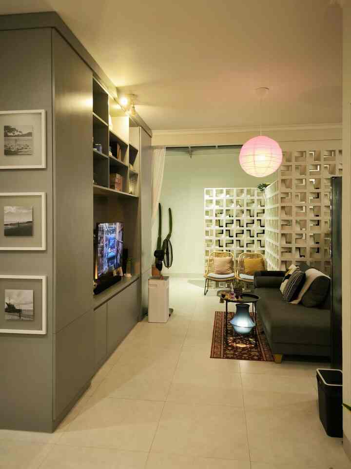 Gray and charcoal toned living room featuring a sofa and balcony chairs, creating a cozy atmosphere