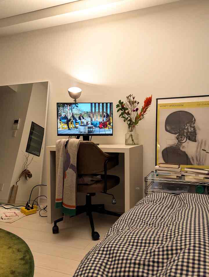 Minimal natural workspace in white and brown tones, featuring a desk, office chair, full-length mirror, and cozy atmosphere