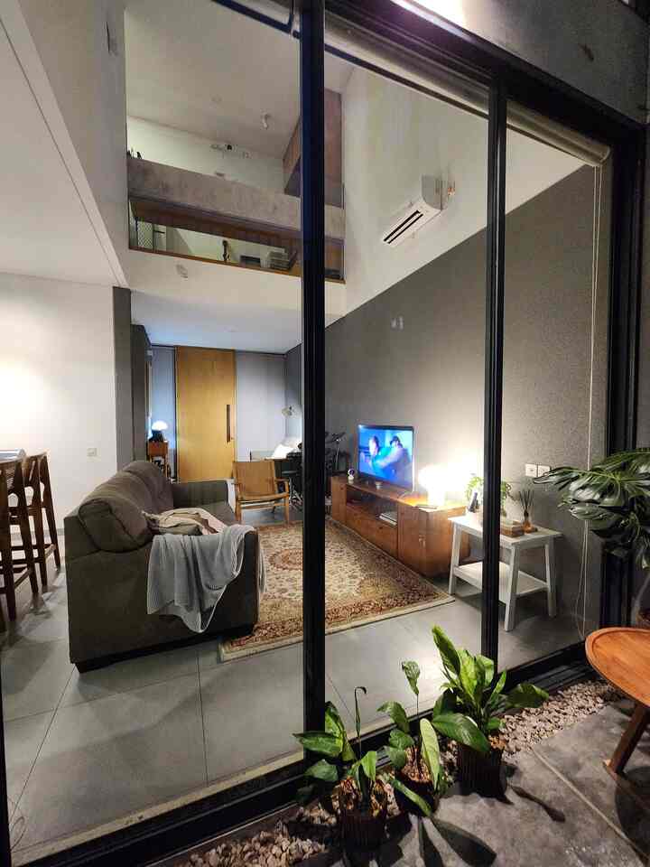 Natural modern living room featuring a fabric sofa and wood furniture with a cozy and comfortable atmosphere