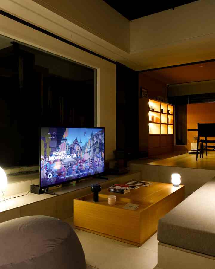 A warm natural color living room featuring a gray sofa, wood-tone coffee table, and cozy lamps in a modern setting