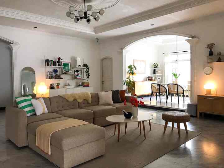 White and brown toned living room featuring beige sofa and coffee table with a natural modern vibe
