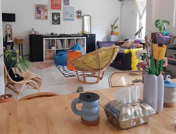 Bright natural tone living room featuring sofa, bean bag and yellow accents with cozy atmosphere