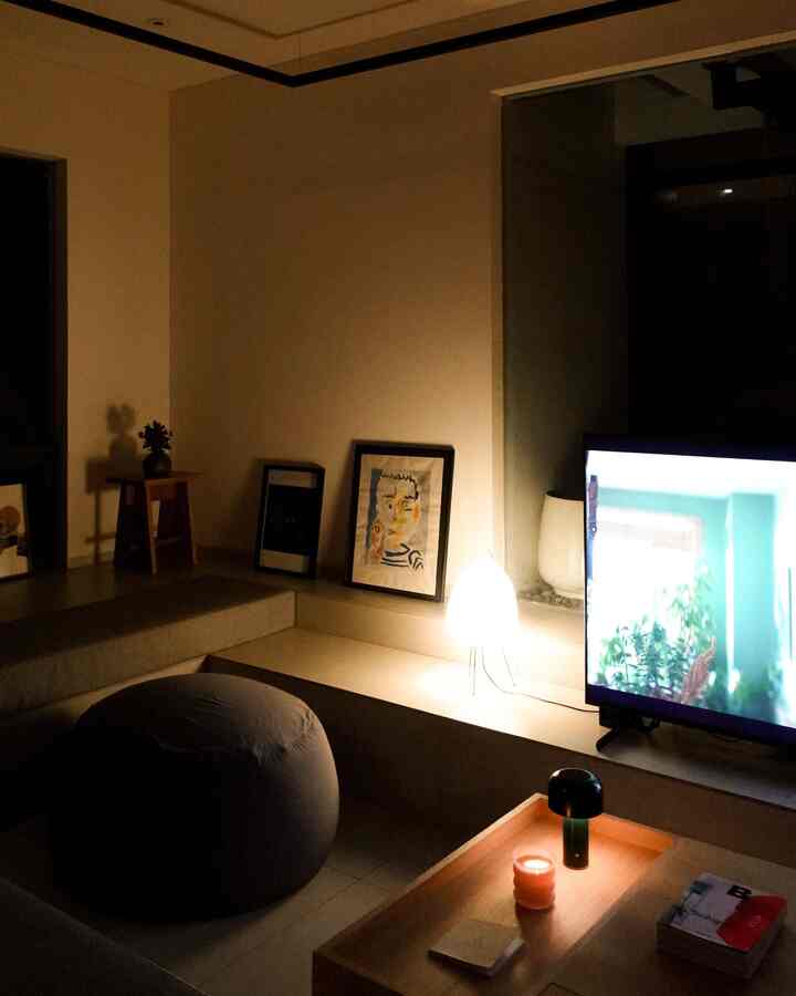 Warmly lit living room featuring a bean bag sofa and table lamp creating a cozy atmosphere
