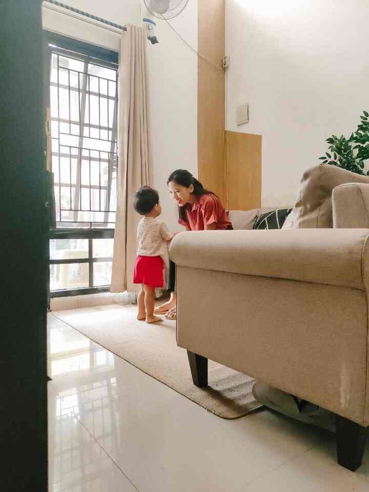 Beige and white-toned living room featuring sofa and carpet, warm and simple family space