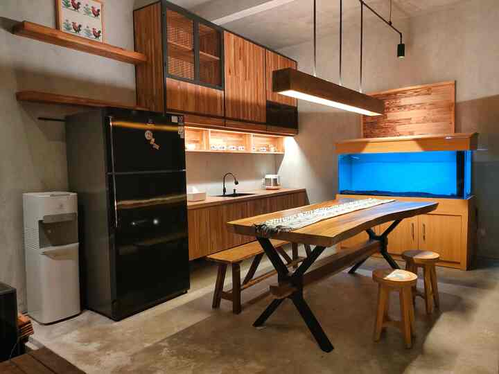 Dapur yang sejajar dengan ruang makan-pantry,membuat akses menyajikan makanan lebih cepat.
Kami memisahkan dapur-ruang makan dengan kolam ikan indoor dan jembatan kayu Ulin. Adanya kolam ikan indoor memberikan suasana lebih sejuk di ruangan dapur sehingga memasak menjadi lebih nyaman.
Interior dapur kita fokuskan warna abu "stone" dari lantai dan backsplash menggunakan keramik yang sama.Table top cukup dengan "concrete cement" untuk kesan industrial.Untuk totalitas industrial kitchen set dipasang memakai HPL motif stone. Tone warna senada ini cukup membantu membuat kesan ruangan dapur lebih luas,meski kenyataannya dapur cukup kecil.
Kontras dengan ruang makan-pantry.Interior dibuat lebih "warm" dari warna kayu dan aksen industrial di bagian lighting. Solid table menjadi point' of view ruang makan. Tips untuk membuat ruang menjadi lebih luas adalah dengan memilih furniture dan peralatan rumah tangga masih di tone yang sama.
LESS IS MORE
#MejamakanMinimalis  #KitchenSet #KictchenSetMinimalis #BlackSplashKitchen #MakeOverDapur #StylingDapur #DapurImpian 
#DapurMinimalis #DapurSegaris #DapurMungil #KayuJati #KayuSolid #HPL #semen